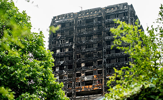 Ett svart utbrunnet höghus vilket är Grenfell tower som brann i London 2017